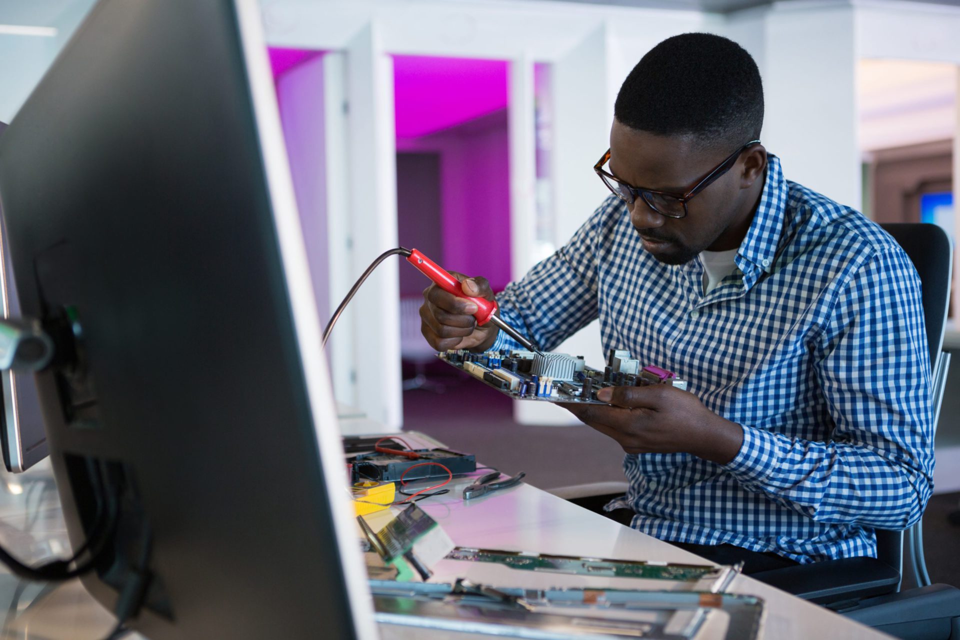 Computer African American Engineer Repairing Motherboard At Desk Blog